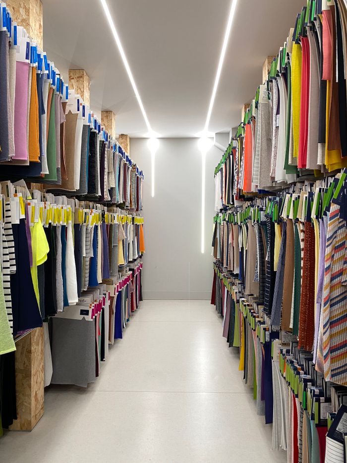 Explore colorful textiles in a retail aisle showcasing diverse patterns and materials. Ideal for fashion inspiration.